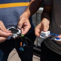 <p>Close-up view of Omer Inan and Samer Mabrouk holding prototypes of their new sensor</p>