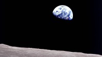 Earth peeking out from beyond the lunar surface.