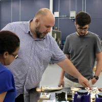 <p>Aaron Stebner (second from left), associate professor in the College of Engineering, leads a lab session with students in the Delta Air Lines Advanced Manufacturing Pilot Facility at Georgia Tech. (Photo: Christa M. Ernst)</p>
