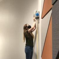 <p>ChBE PhD student Sabrina Westgate installs an air sensor to monitor classroom air quality.</p>