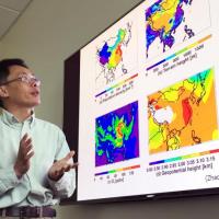 <p>Georgia Tech Professor Yuhang Wang explains maps showing terrain, population density and other issues affecting haze formation in the East China Plains during winter months. (Credit: John Toon, Georgia Tech)</p>
