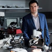 Fatih Sarioglu, an assistant professor in the Georgia Tech School of Electrical and Computer Engineering, is shown in his laboratory, where microfluidic devices are fabricated and tested. (Credit: Rob Felt)