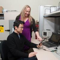 <p>Georgia Tech Graduate Research Assistant Sihwan Kim and Professor Jennifer Hasler are developing an application for the FPAA device. They are using design tools on the laptop computer and evaluating a demonstration on the handheld tablet driving the FPAA device. (Credit: Fitrah Hamid, Georgia Tech)</p>