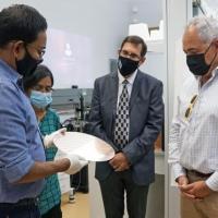 <p>Asif Khan (left) discusses his research with Georgia Tech President Angel Cabrera (right) during a 2021 visit to Khan's lab.</p>