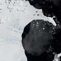 <p>Before its sudden shattering, numerous meltwater ponds riddled Antarctic ice shelf Larsen B. They are seen in this 2002 satellite image as a matrix of aquamarine spots. Scientists believe that the ponds hydrofractured the kilometer-thick ice shelf, causing its swift destruction. Credit: NASA Earth Observatory</p>