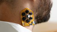 a patch of haptic actuators shown on a user's neck