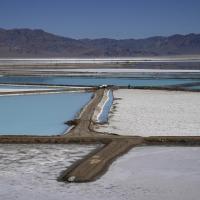 A truck is parked betwenn brine evaporation ponds at Albemarle Corp's Silver Peak lithium facility, Oct 6, 2022, in Silver Peeak, Nev. The Energy Department is making a push to strenghten the U.S. battery supply chain, announcing Wednesday, Nov 15, 2023, up to $3.5 billion for companies that produce batteries and the critical minerals that go into them. (AP Photo/John Locher, File)