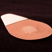 <p>This close-up image shows the microneedle vaccine patch, which contains tiny needles that dissolve into the skin, carrying vaccine. A majority of study participants said they would prefer to receive the influenza vaccine using patches rather than traditional hypodermic needles.</p>