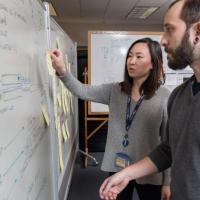 <p>GTRI Research Scientist Andew Baranak and Georgia Tech Graduate Student Rachel Chen discuss creating user interface workflows for the mission planning task. (Credit: Rob Felt, Georgia Tech)</p>
