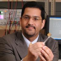 <p>Muhannad Bakir, a professor in the School of Electrical and Computer Engineering, holding a monolithic microelectronics chip. He brings a breadth of knowledge to the shift from monolithic microelectronics to heterogeneous integration. (Photo credit: Robert Felt, Georgia Tech)</p>