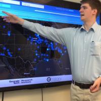 <p>Georgia Tech Research Institute (GTRI) Research Scientist Trevor Goodyear shows features of U.S. News Map, a database of more than 10 million newspaper pages that is helping researchers see history with spatial information that hadn’t been available before. (Credit: Georgia Tech).</p>