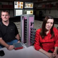 <p>Georgia Tech Graduate Student Paul Rose and Assistant Professor Anna Erickson are shown with Cherenkov quartz detectors that would be used to image shielded radioactive materials inside cargo containers. (Credit: Rob Felt, Georgia Tech)</p>