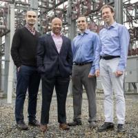 <p>Georgia Tech researchers Tohid Shekari, Raheem Beyah, Morris Cohen, and Lukas Graber are shown with a substation that is part of the electric grid. The researchers have developed a new technique to secure the substations. (Image: Christopher Moore, Georgia Tech)</p>