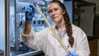 Georgia Tech grad student holding a hollow fiber membrane that can be used for low-energy chemical separation.
