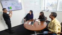 Rampi Ramprasad and three members of his research team discuss their AI model for generative polymer design in his office.
