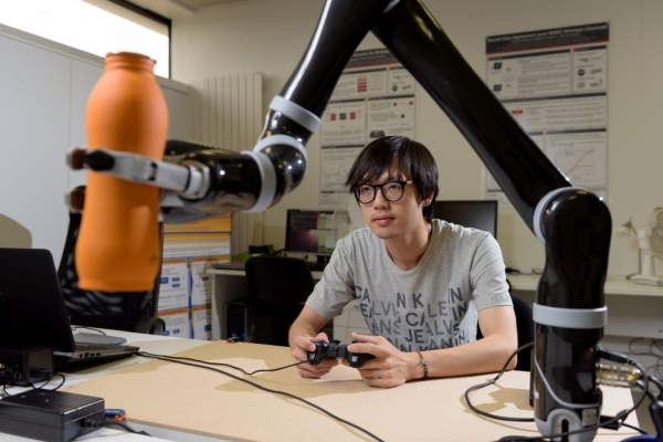 Student working on basic robot arm manupulation task